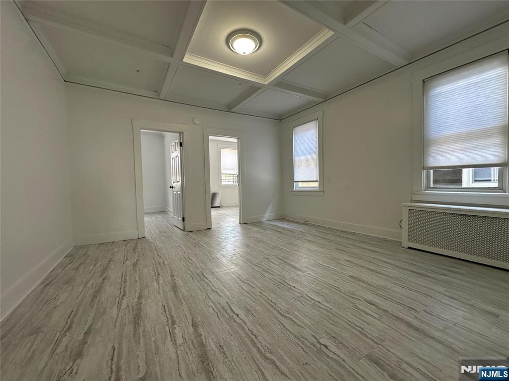 526 Valley Brook Avenue, Unit 2 Lyndhurst, NJ 07071 - Photo 4 of 13 an empty room with wooden floor and windows