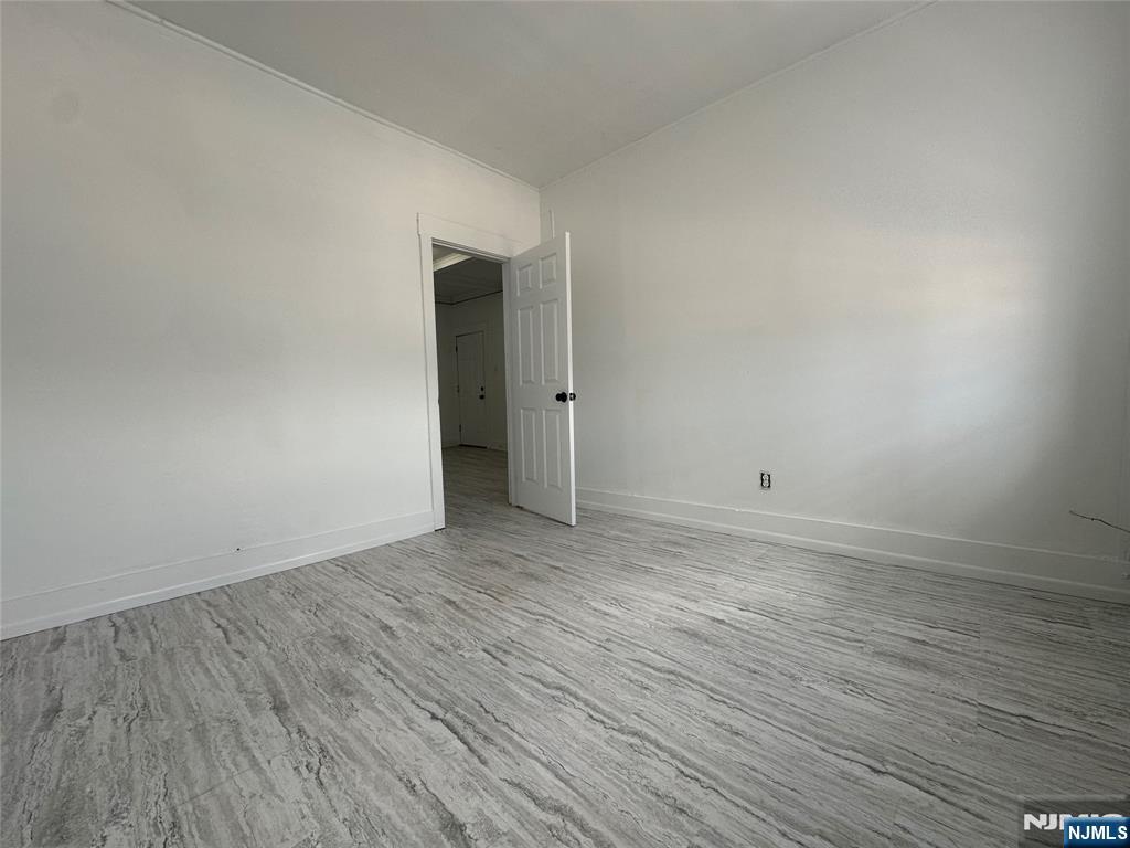526 Valley Brook Avenue, Unit 2 Lyndhurst, NJ 07071 - Photo 8 of 13 a view of an empty room with wooden floor and closet
