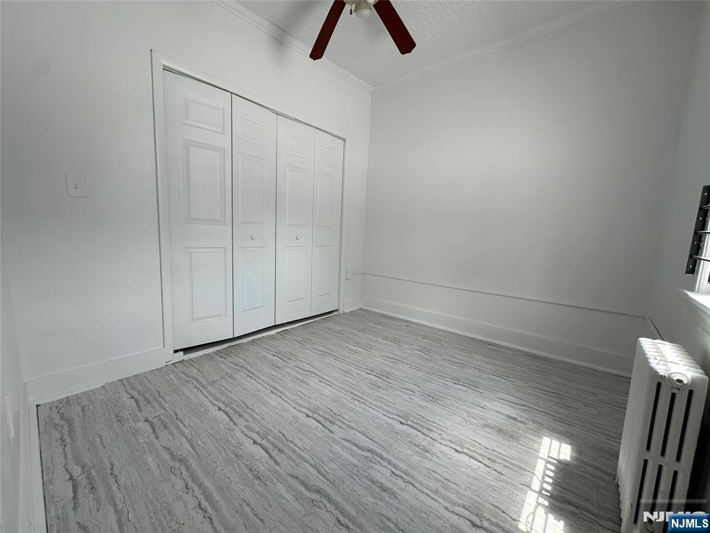 526 Valley Brook Avenue, Unit 2 Lyndhurst, NJ 07071 - Photo 10 of 13 a view of an empty room with wooden floor and window