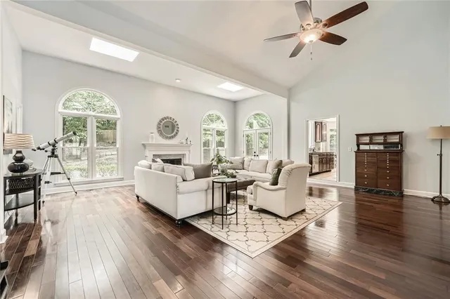 a kitchen with a sink a counter top space and living room area