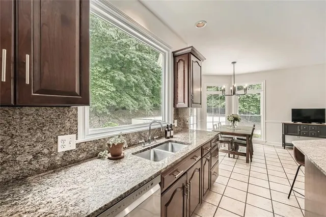 a dining room with furniture a chandelier and window
