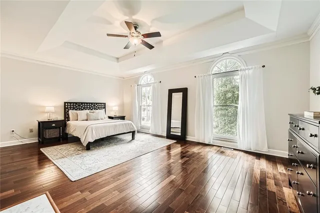 a view of a hallway with front door and wooden floor