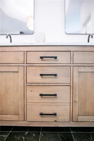 a view of a bedroom with furniture and book shelf