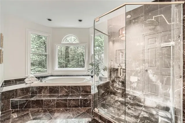 a white toilet sitting next to a bath tub and a shower