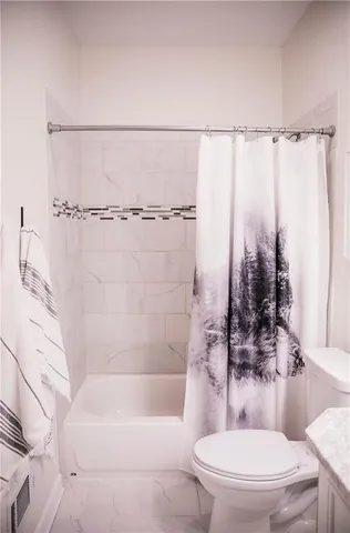 a view of a room with rack on the wall and a window