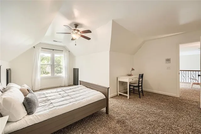 a bedroom with a bed chair and a window