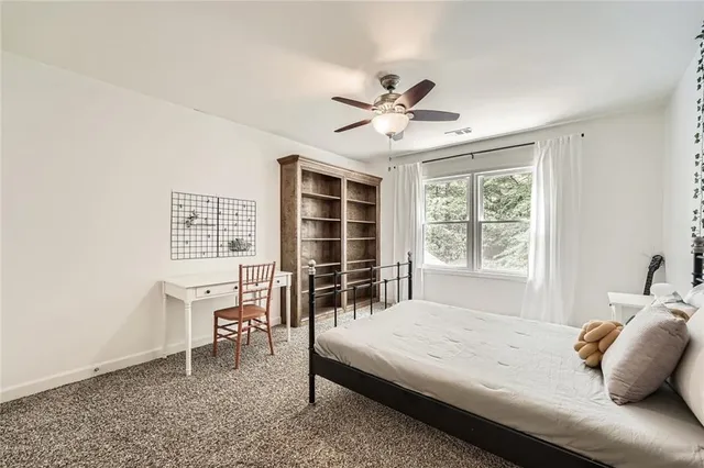 a view of a dining room with furniture and a chandelier