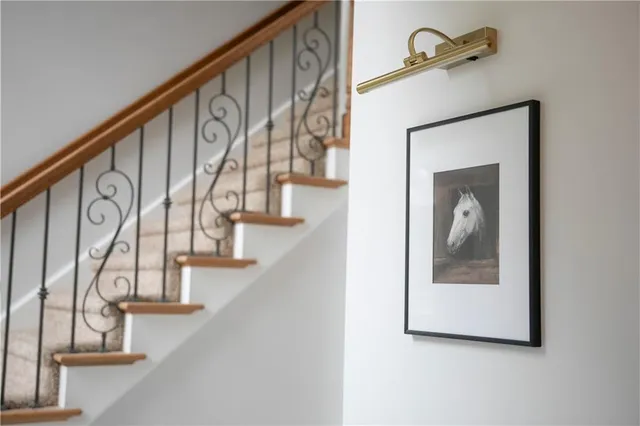 a living room with furniture fireplace and a large window
