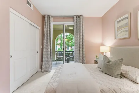 a bedroom with a large bed and a window