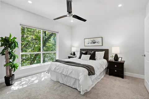 a spacious bedroom with a large bed and a large window