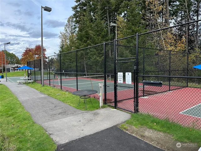 a view of a backyard with wooden fence