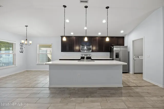 a view of a kitchen with a chandelier