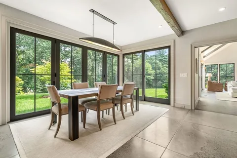 a dining room with furniture mountain view and balcony