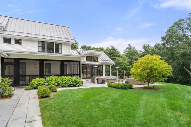 a front view of a house with a yard and green space