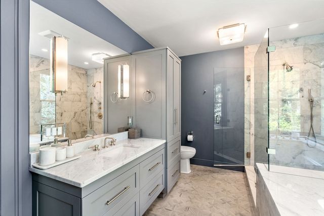 a bathroom with a double vanity sink mirror double shower and a bathtub