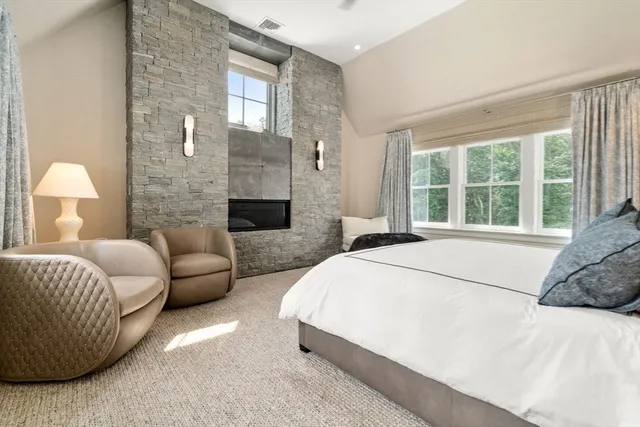 a spacious bedroom with a bed and a couch