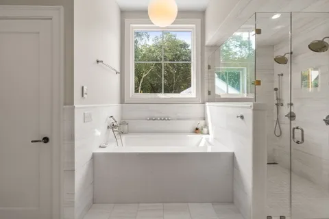 a bathroom with a bathtub and a shower