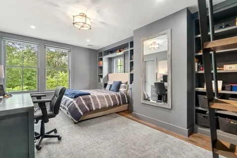 a bedroom with a large bed and a chandelier