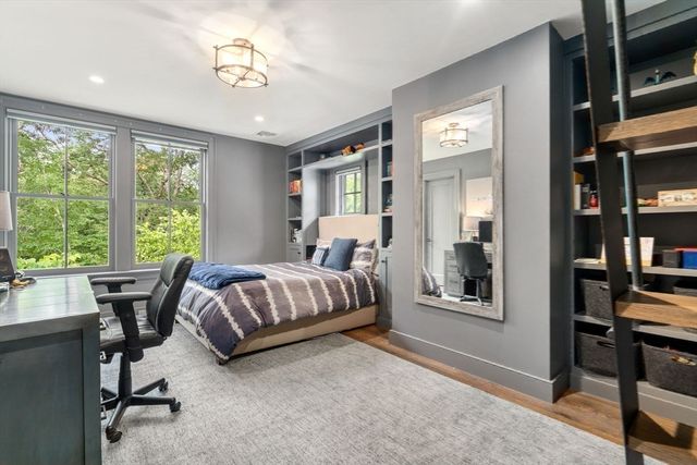 a bedroom with a large bed and a chandelier