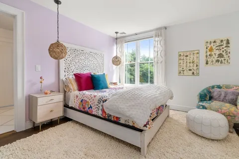 a bed room with a bed and a window