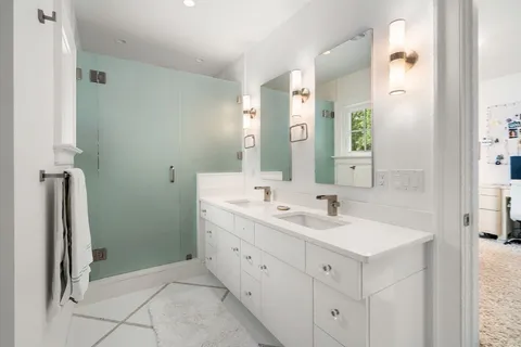 a bathroom with a double vanity sink and mirror