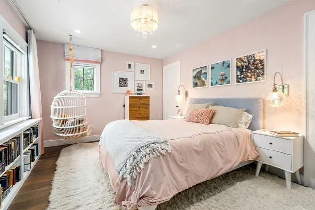 a bedroom with a large bed and a window