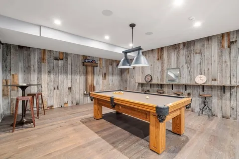 a kitchen with stainless steel appliances granite countertop a sink a stove and a wooden floors