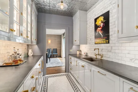 a kitchen with stainless steel appliances a sink a stove and cabinets