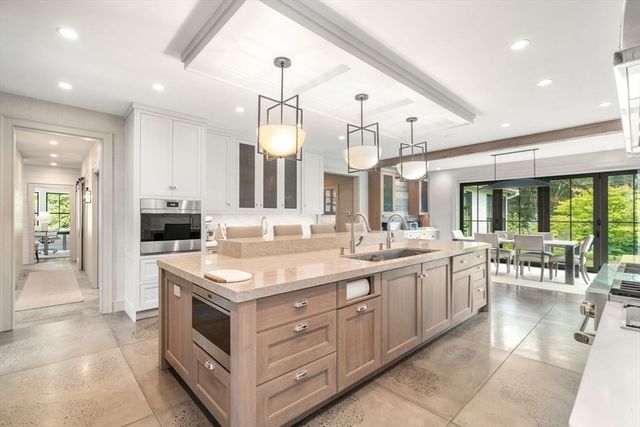a large kitchen with a large counter top appliances and cabinets
