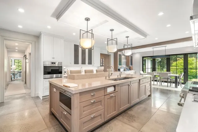 a large kitchen with a large counter top appliances and cabinets