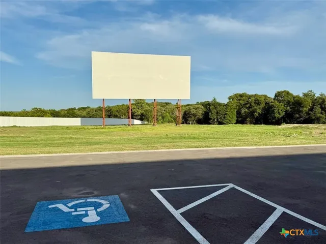a front view of a house with a road