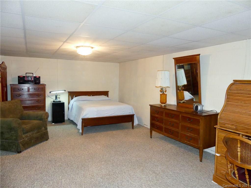 401 Poors Ford Road Rutherfordton, NC 28139 - Photo 22 of 34 a bedroom with a bed and a dresser in it