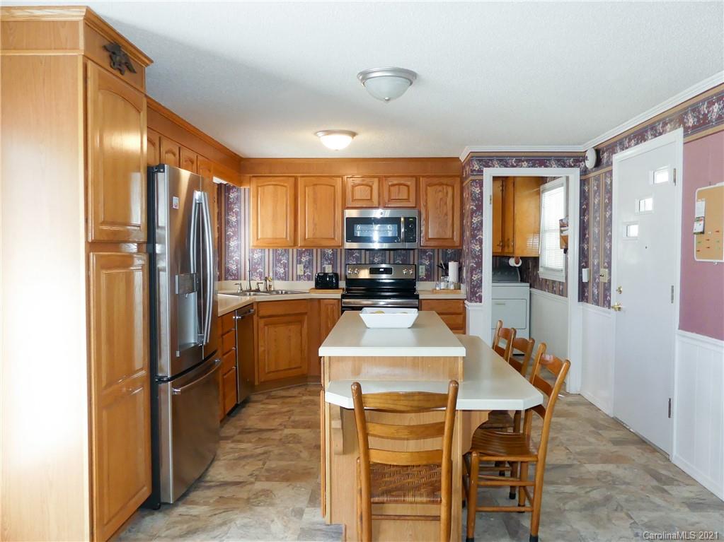 401 Poors Ford Road Rutherfordton, NC 28139 - Photo 8 of 34 a kitchen with granite countertop a refrigerator and a stove top oven