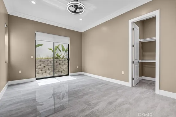 an empty room with windows and closet