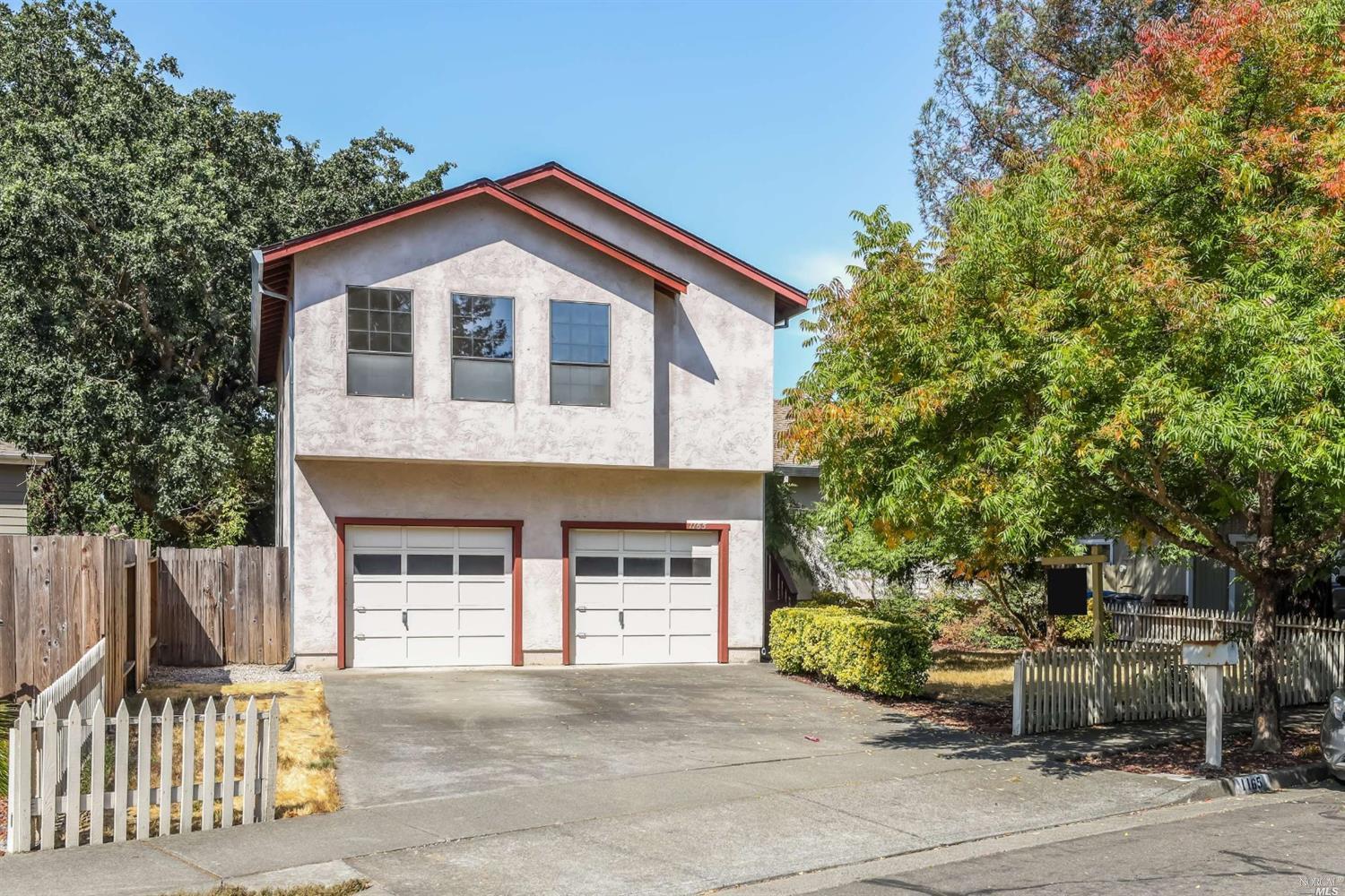 1165 Guaymas Street Santa Rosa, CA 95401 - Photo 1 of 1 a front view of a house with a garden and trees