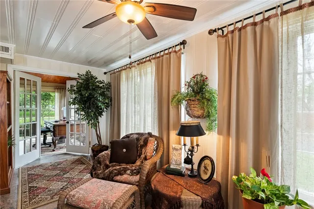 a living room with furniture and a potted plant