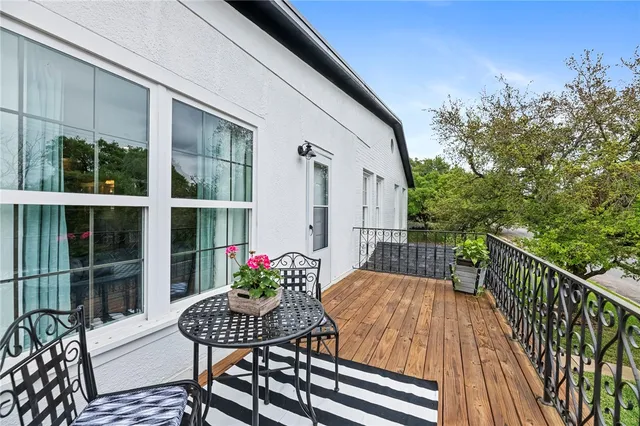 a view of a chair and tables in the balcony
