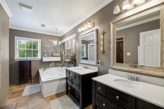 a bathroom with a tub sink and mirror
