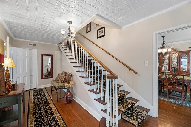 a view of entryway and hall with wooden floor