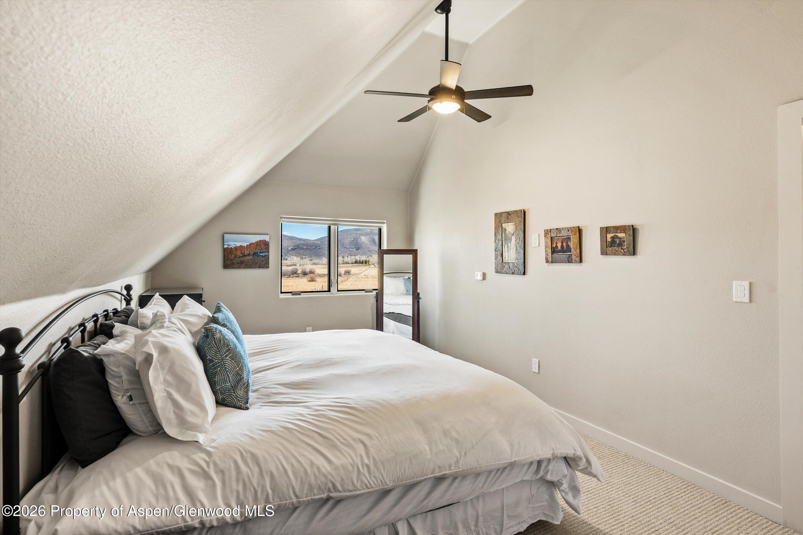 90 Alexander Avenue Snowmass, CO 81654 - Photo 17 of 26 a bedroom with a bed and a mirror