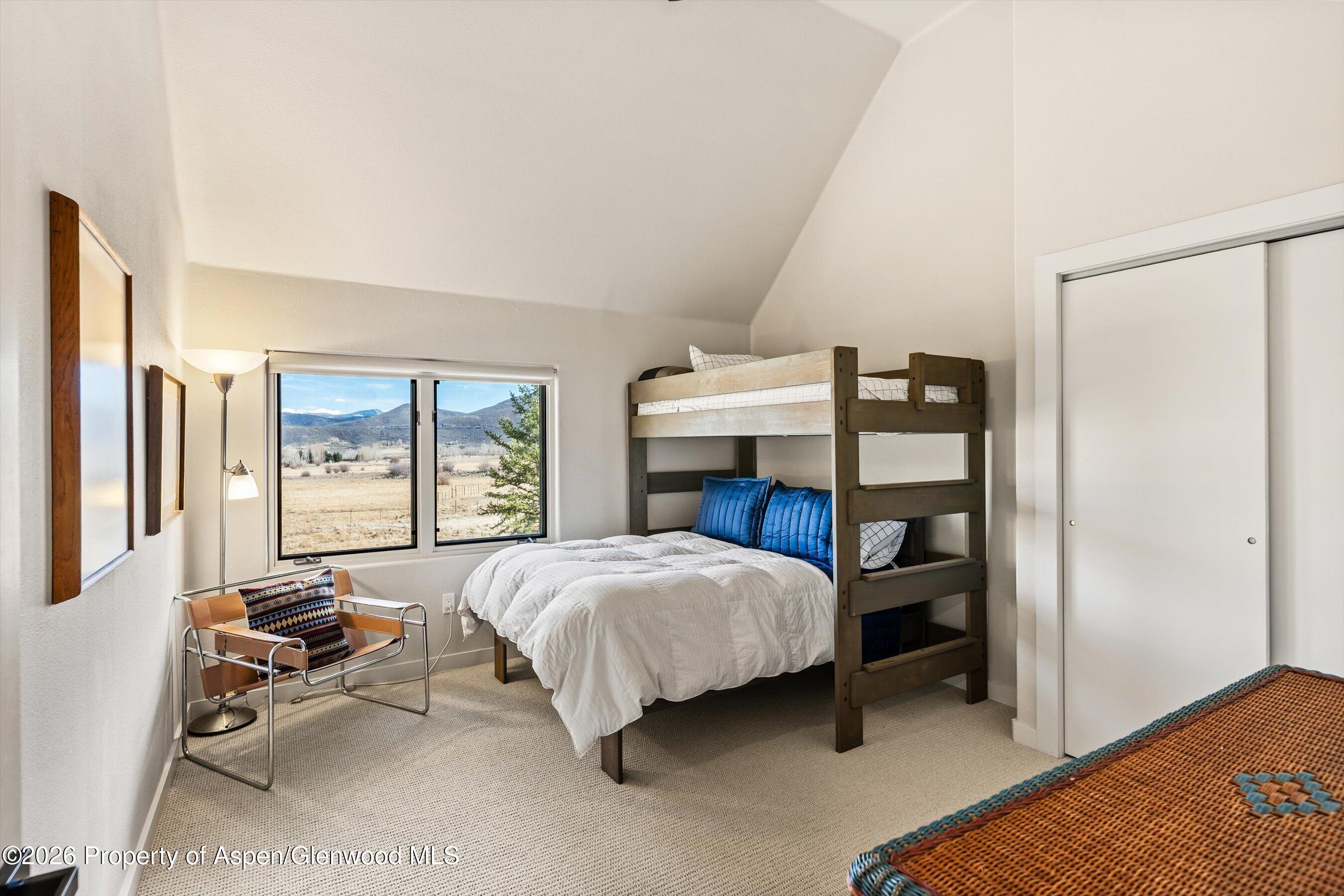 90 Alexander Avenue Snowmass, CO 81654 - Photo 18 of 26 a bedroom with a bed and large window