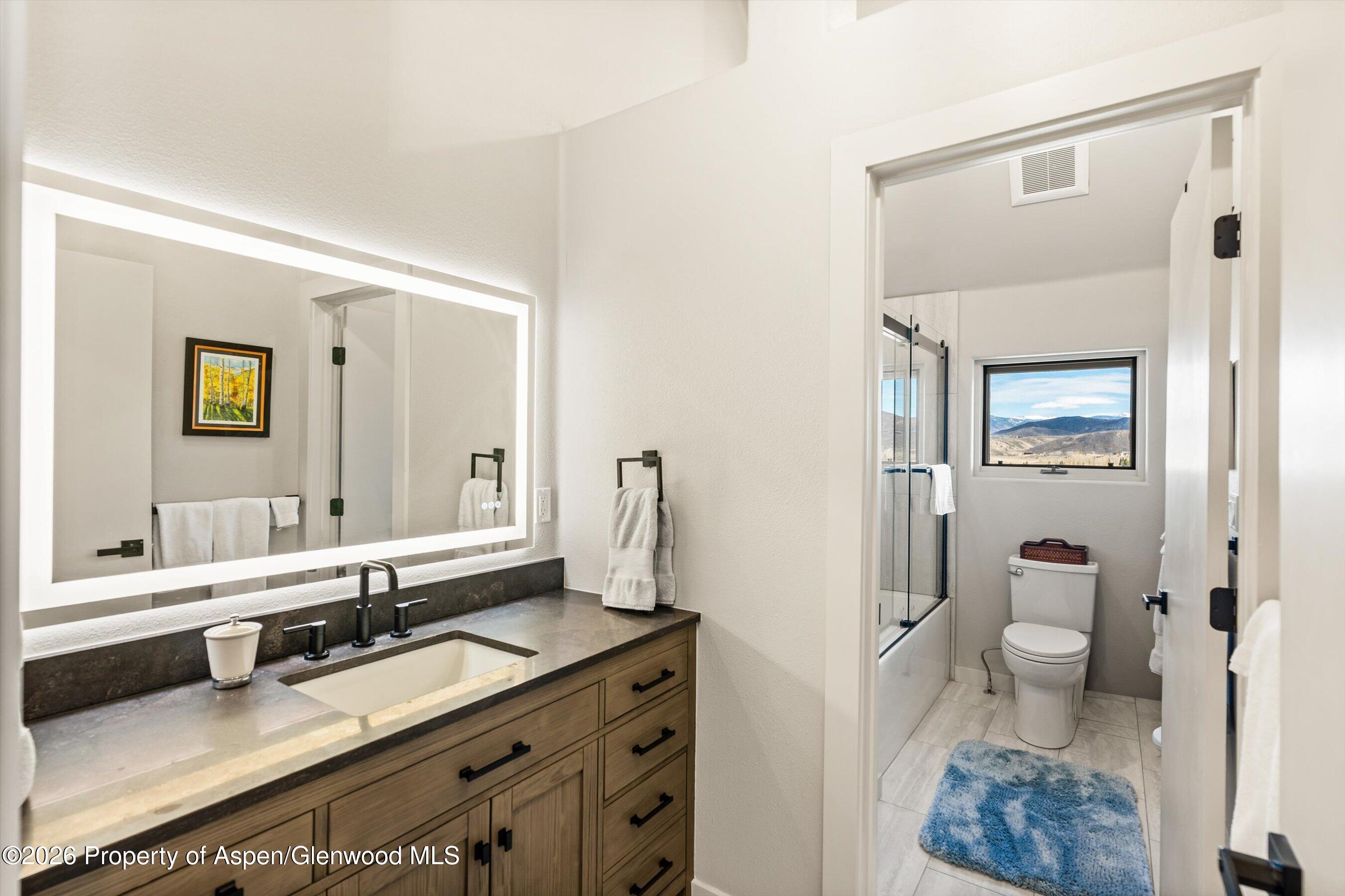 90 Alexander Avenue Snowmass, CO 81654 - Photo 19 of 26 a en suite bathroom with a granite countertop sink and a mirror