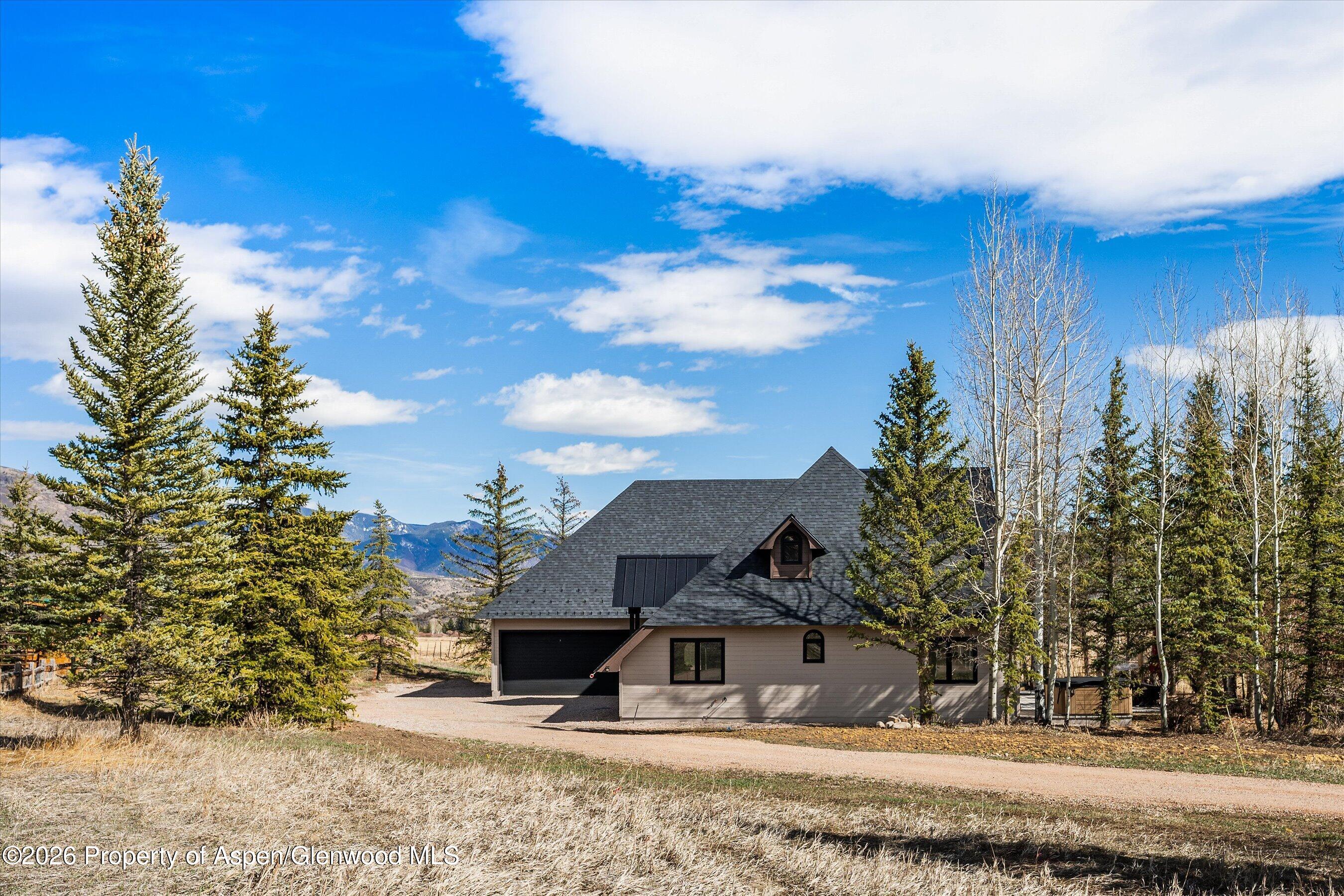 90 Alexander Avenue Snowmass, CO 81654 - Photo 22 of 26 a house with trees in front of it