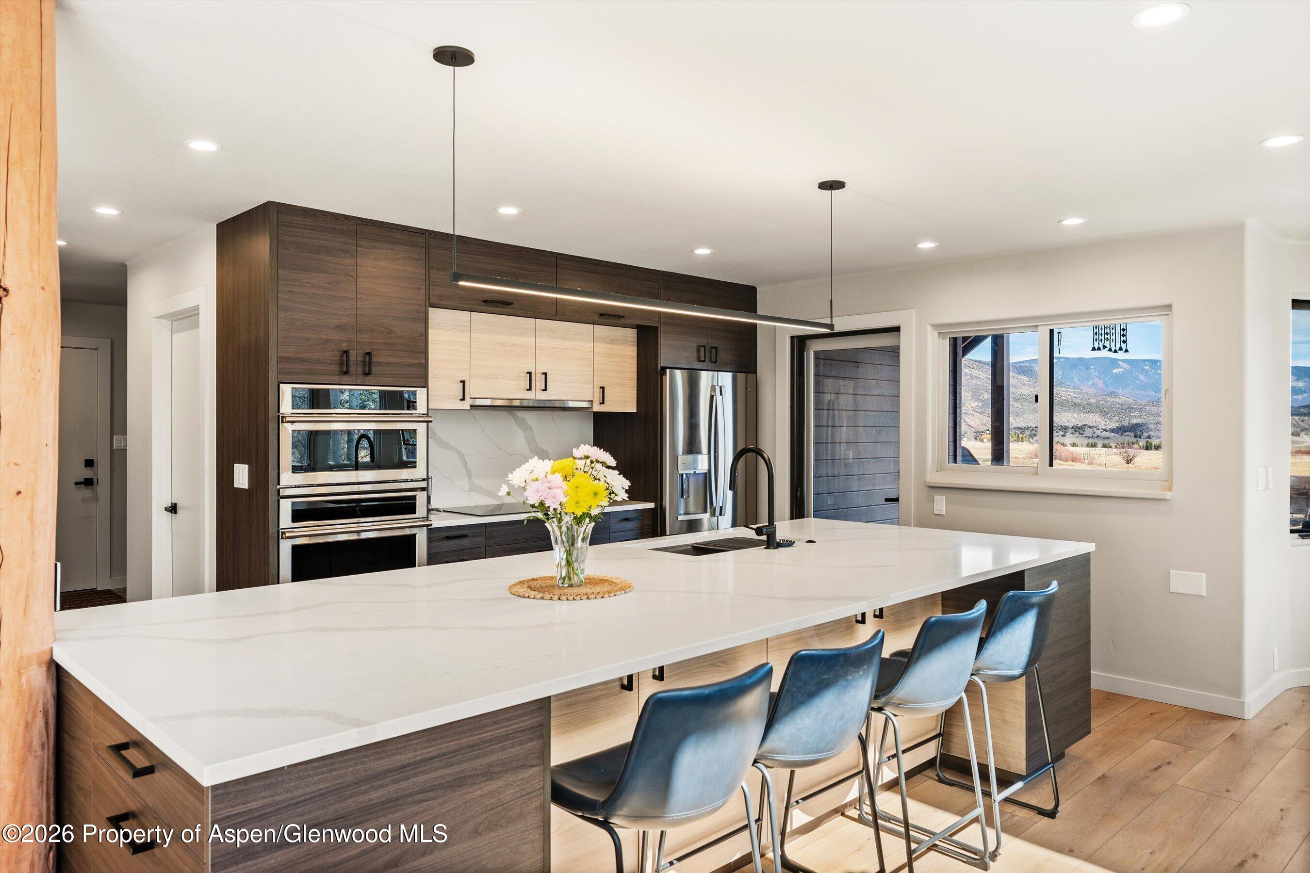 90 Alexander Avenue Snowmass, CO 81654 - Photo 5 of 26 a kitchen with a dining table and chairs