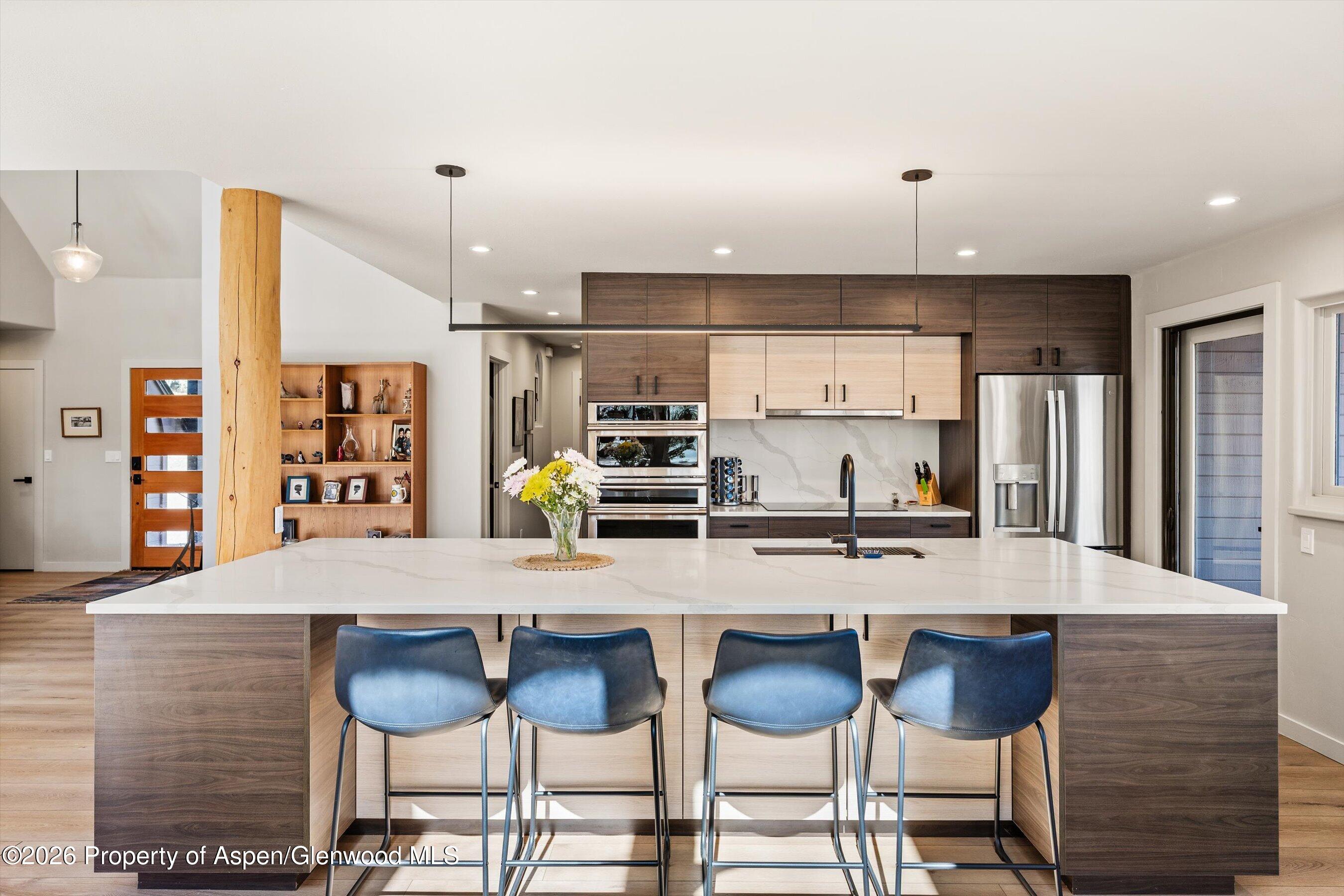 90 Alexander Avenue Snowmass, CO 81654 - Photo 6 of 26 a kitchen with granite countertop a counter space dining table and chairs