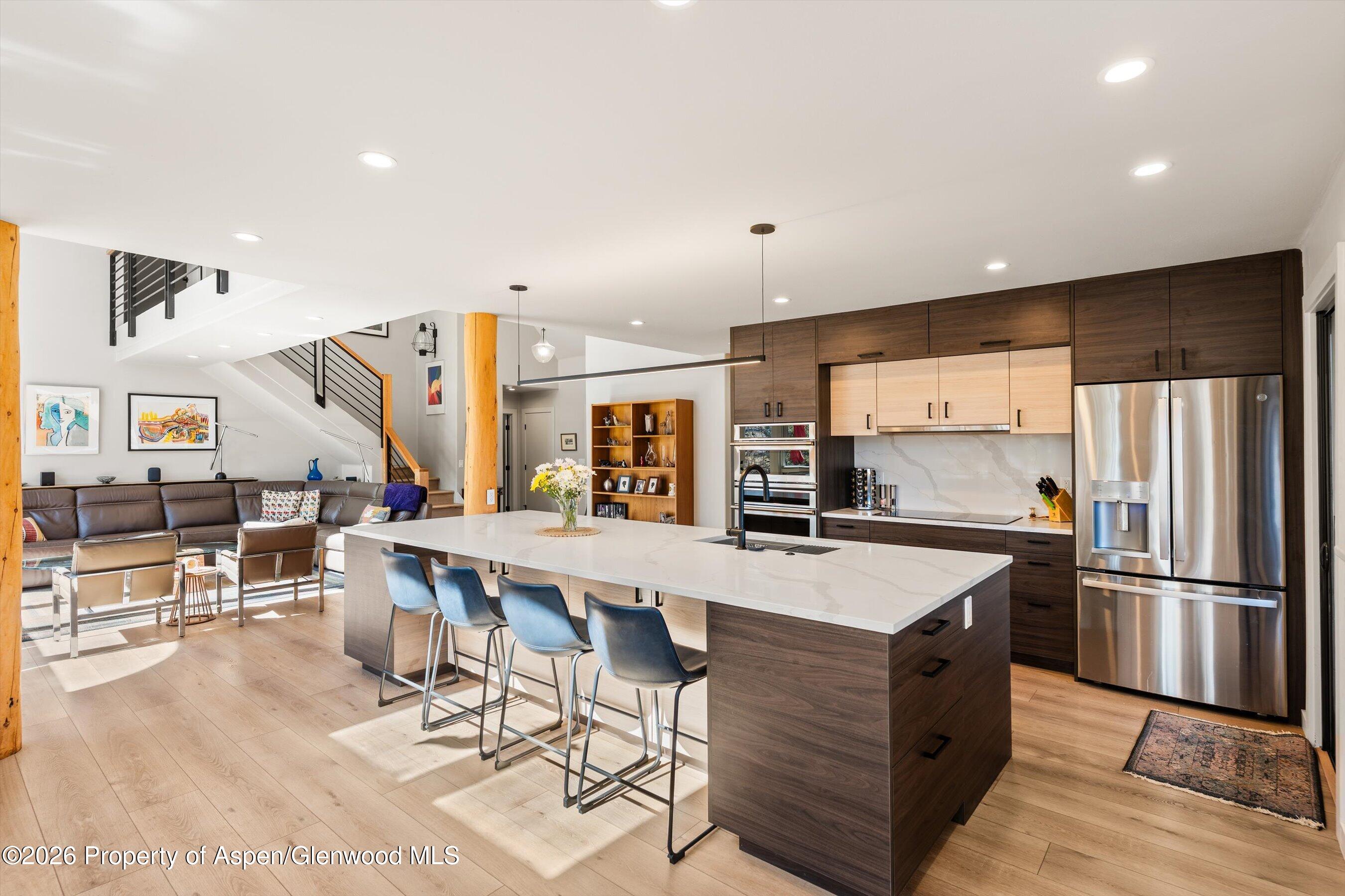 90 Alexander Avenue Snowmass, CO 81654 - Photo 7 of 26 a large kitchen with a table and chairs