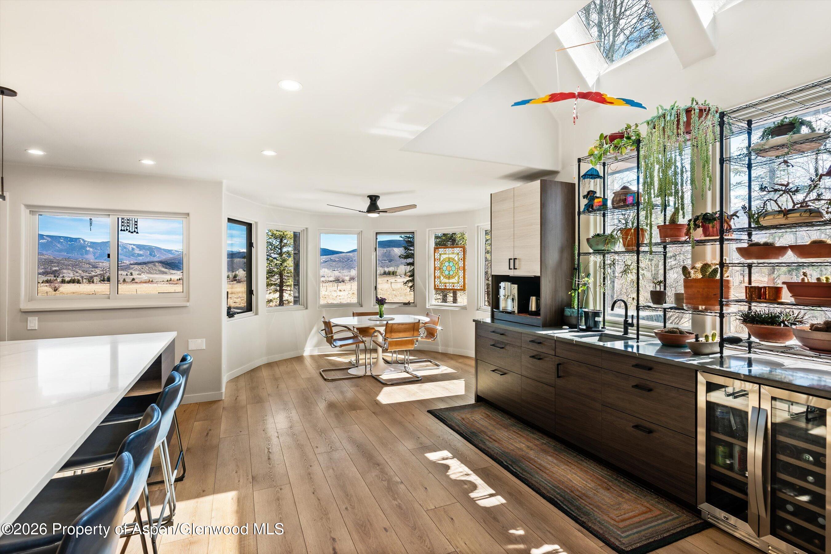 90 Alexander Avenue Snowmass, CO 81654 - Photo 8 of 26 a large kitchen with stainless steel appliances kitchen island granite countertop a large window and a counter space