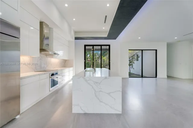 an empty room with windows and ceiling fan