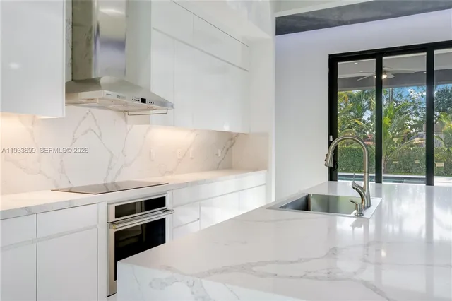 an empty room with ceiling fan and windows