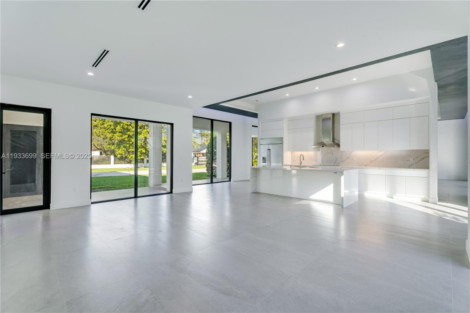 10398 Southwest 64th Street Miami, FL 33173 - Photo 28 of 88 a view of an empty room with wooden floor and a window